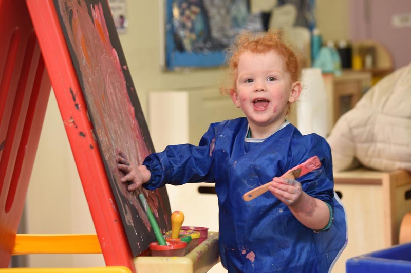 little_girl_blue_jacket_smile_art_preschool_right_horizontal